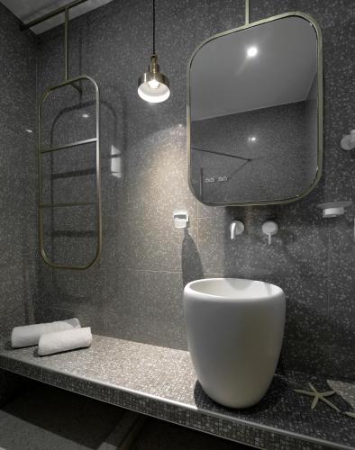 a bathroom with a sink and a large mirror at Castristudios in Nikiti