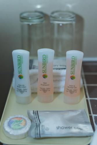 three tubes of sunscreen sitting on a counter with towels at Sunbird Capital in Lilongwe