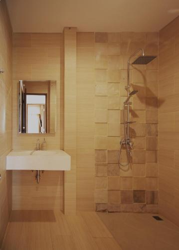 a bathroom with a sink and a shower at Arena Living in Sanur