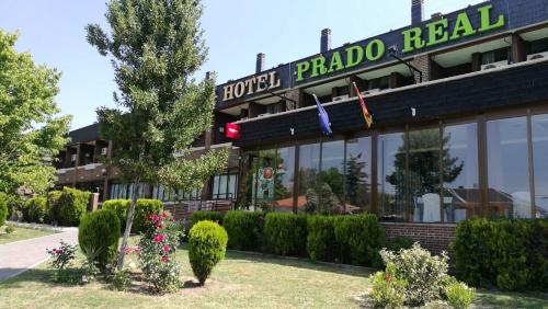 a hotel with a sign on the front of a building at Hotel Prado Real in Soto del Real
