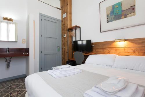 a hotel room with a bed with two towels on it at Gran H La Marina in Altea