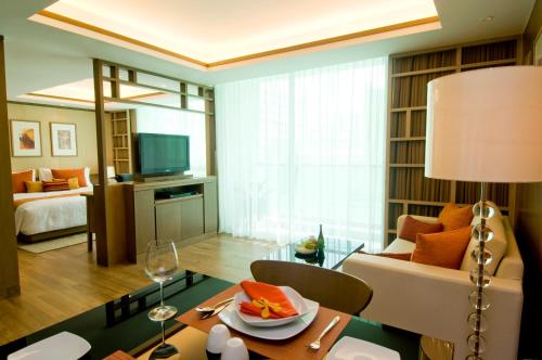 
a living room filled with furniture and a tv at Amari Residences Bangkok - SHA Plus in Bangkok
