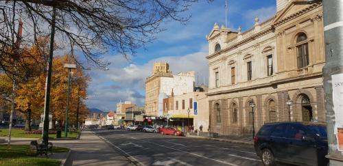 cars are parked in front of a building at The Eastern Hotel in Ballarat