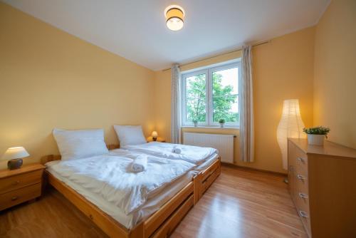 a bedroom with a large bed and a window at RentPlanet - Apartamenty Mickiewicza in Szklarska Poręba