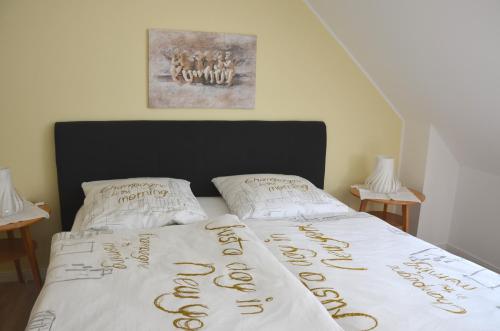 a bed with a comforter that says happy new year at Moni's Ferienwohnung in Bad Bertrich
