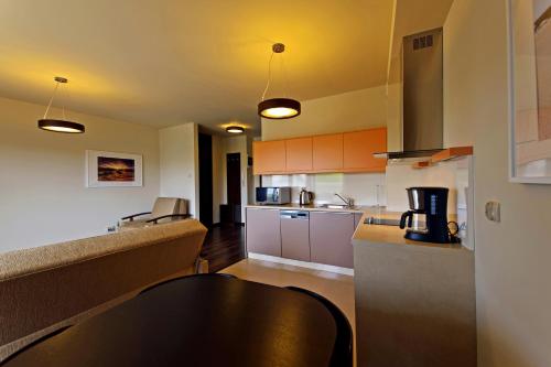 a kitchen with a black table in a room at Foka, Sun & Snow in Hel