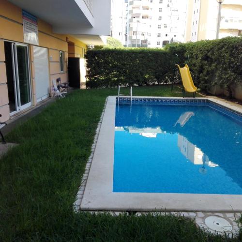 a swimming pool in the yard of a building at Faia Atlantico Apartment in Portimão