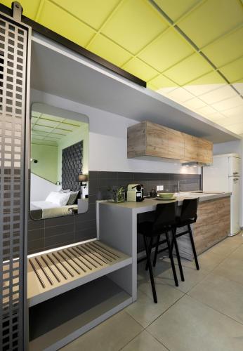 a kitchen with a table and chairs and a bedroom at Castristudios in Nikiti