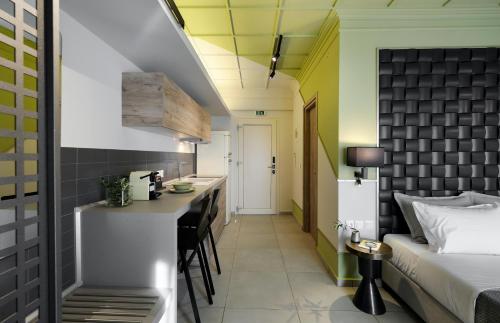 a hotel room with a bed and a kitchen at Castristudios in Nikiti