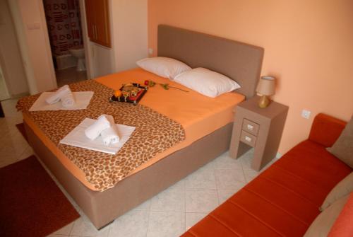 a bedroom with a bed with two towels on it at Guest House Pasha in Ulcinj