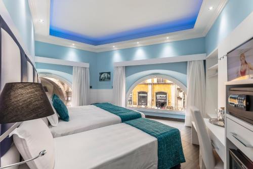 a bedroom with a bed and a bathroom with a sink at THE ONE Boutique Hotel & SPA Rome in Rome