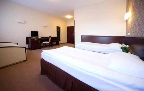 מיטה או מיטות בחדר ב-Hotel Centrum
