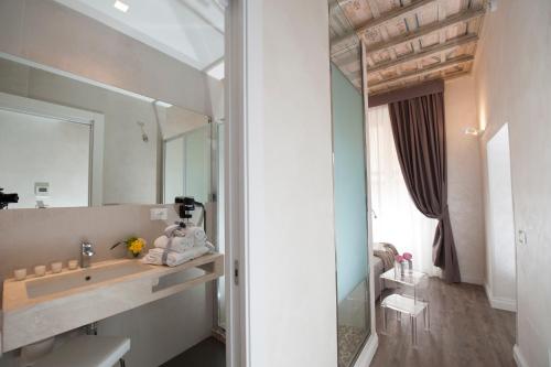 a bathroom with a sink and a mirror at Hotel Navona in Rome