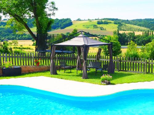 a gazebo and chairs next to a pool at La Belle Verte in Grignols Dordogne