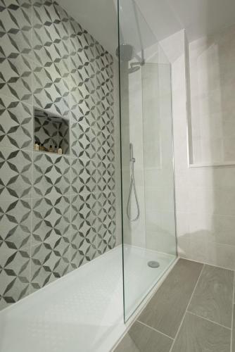 a bathroom with a shower with a glass door at Saltmarshe Hall in Saltmarshe