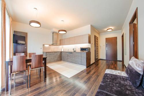 a kitchen and living room with a table and chairs at Foka, Sun & Snow in Hel