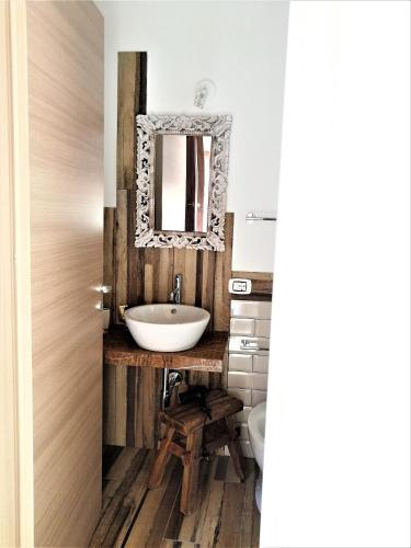 a bathroom with a sink and a mirror at Casa Busari in Palermo