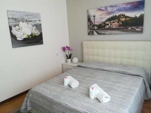 a bedroom with a bed with two towels on it at A casa di Luca in Verona