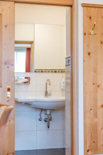a bathroom with a sink and a mirror at Doerr Landhotel & Spa in Bad Laasphe