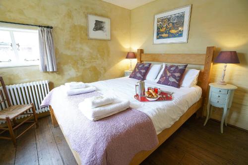 オールドバラにあるHidden Cottage, Aldeburghのベッドルーム1室(タオル付)