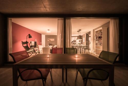 a living room with a wooden table and chairs at Independance First in Interlaken