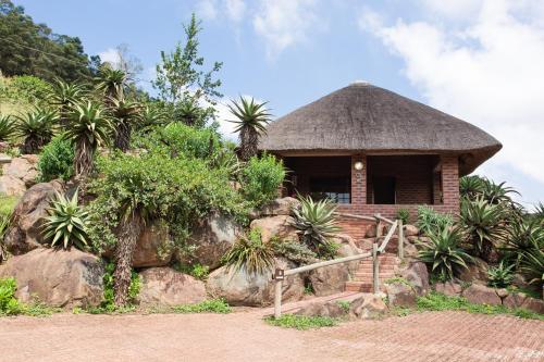 a small hut with a thatched roof at iNsingizi Lodge in Mid Illovo