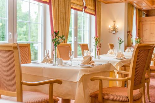 a dining room with long tables and chairs at Doerr Landhotel & Spa in Bad Laasphe