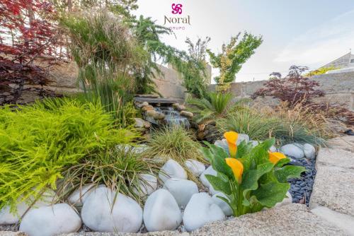 a garden with white rocks and plants at Nuevo Norat Sanxenxo in Sanxenxo