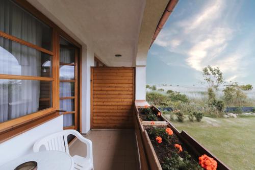 a balcony with a table and chairs and a window at Hotel Mörbischerhof in Mörbisch am See