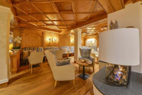 a living room with a table and chairs and a fireplace at Doerr Landhotel & Spa in Bad Laasphe