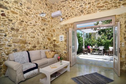 a living room with a couch and a table at Mousa Thalia in Kissamos