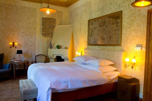 a bedroom with a large bed with white sheets and pillows at Zabola Estate - Transylvania in Zăbala