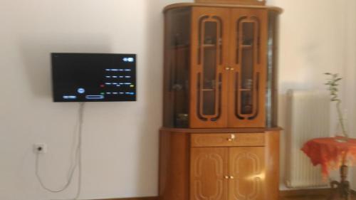a large wooden cabinet with a tv on a wall at Apartment on Dimitrakopoulou in Athens