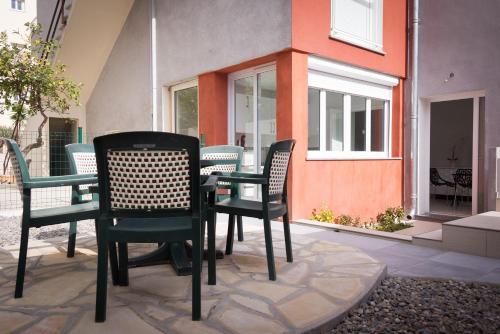 a patio with chairs and a table in front of a building at Hotel et Appartements Reine D'Azur in Roquebrune-Cap-Martin