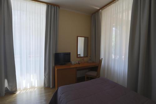 Una televisión o centro de entretenimiento en Oberig Hotel