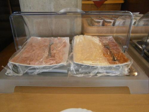 two trays of food sitting on top of a refrigerator at Hotel Chiara in Sirmione