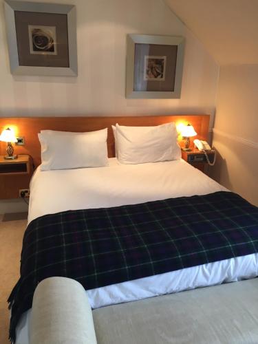 a hotel room with a large bed with two pillows at The Waterfront in Portpatrick