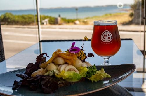 a plate of food on a table with a drink at Samsø Perlen in Sælvig