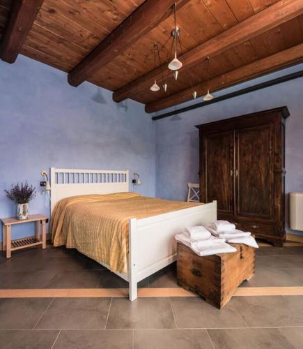 a bedroom with a large bed and a wooden ceiling at Agriturismo Gallo in Cortemilia