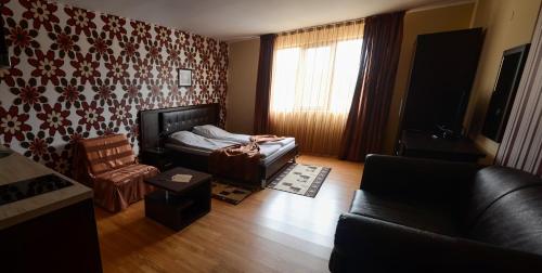 a living room with a couch and a chair at Hotel Alegra in Velingrad