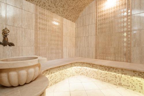 a bathroom with a tub and a sink at Relita-Kazan Hotel in Kazan
