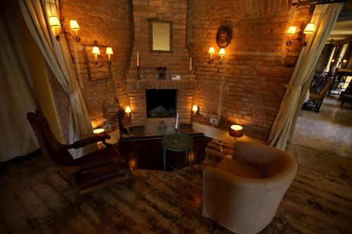 a living room with a couch and a fireplace at Zabola Estate - Transylvania in Zăbala