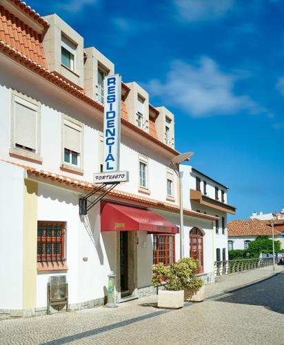 a building with a sign for a hotel at Residencial Fortunato in Ericeira