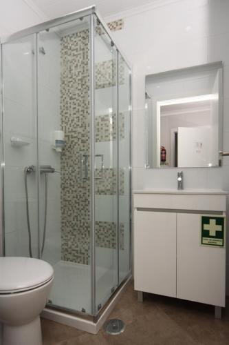 a bathroom with a shower and a toilet and a sink at FerhouseDreams-Praia in Nazaré