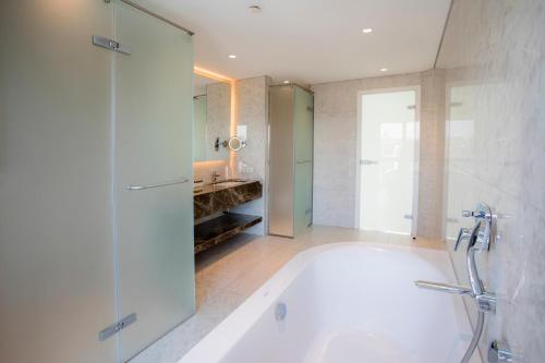 ein Bad mit einer Badewanne, einer Dusche und einem Waschbecken in der Unterkunft Wish More Hotel Istanbul in Istanbul