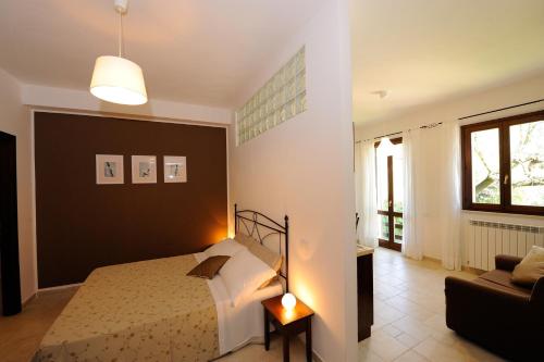 a bedroom with a bed and a couch at Agriturismo Il Vecchio Mandorlo in Perugia