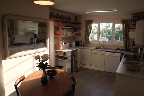a kitchen with a wooden table and a table and a dining room at Spacious home in Bath, nature and city! in Bath