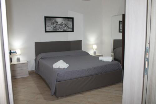 a bedroom with a bed with a cloud pillow on it at Casa vacanze le Egadi Marsala in Marsala