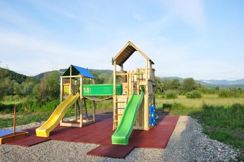 a playground with a slide at Dacii Liberi Resort and Spa in Petrova