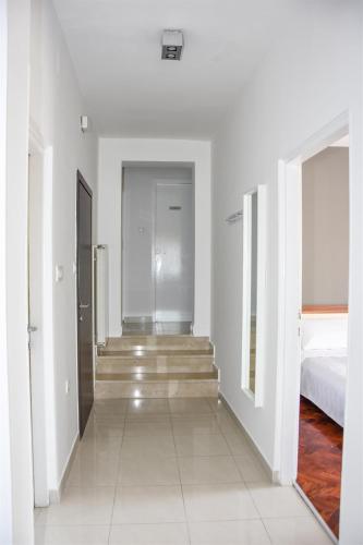 a hallway with stairs and a bed in a room at Crnika in Mandre